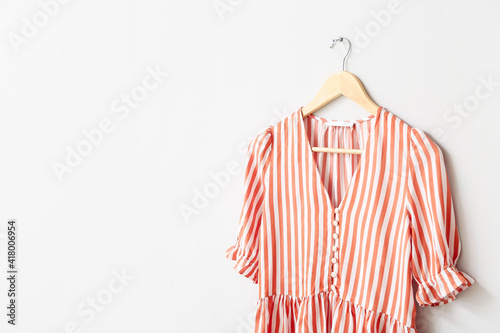 Hanger with blouse on white background
