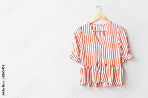 Hanger with blouse on white background photo