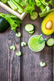 Vegan diet and nutrition, healthy detox, vegetarian concepts drinks. Green smoothie celery, avocado, cucumber and spinach on a rustic table. Top view flat lay. Copy space.