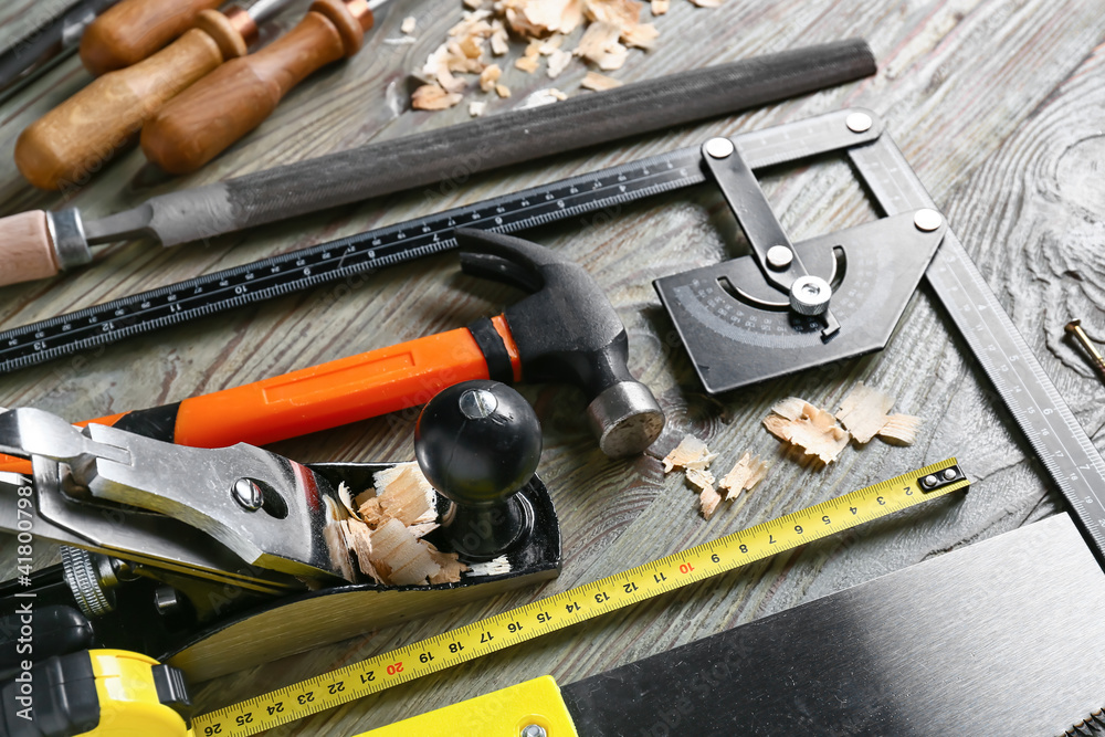 Set of carpenter's tools and saw dust on wooden background Set of carpenter's tools and saw dust on wooden background