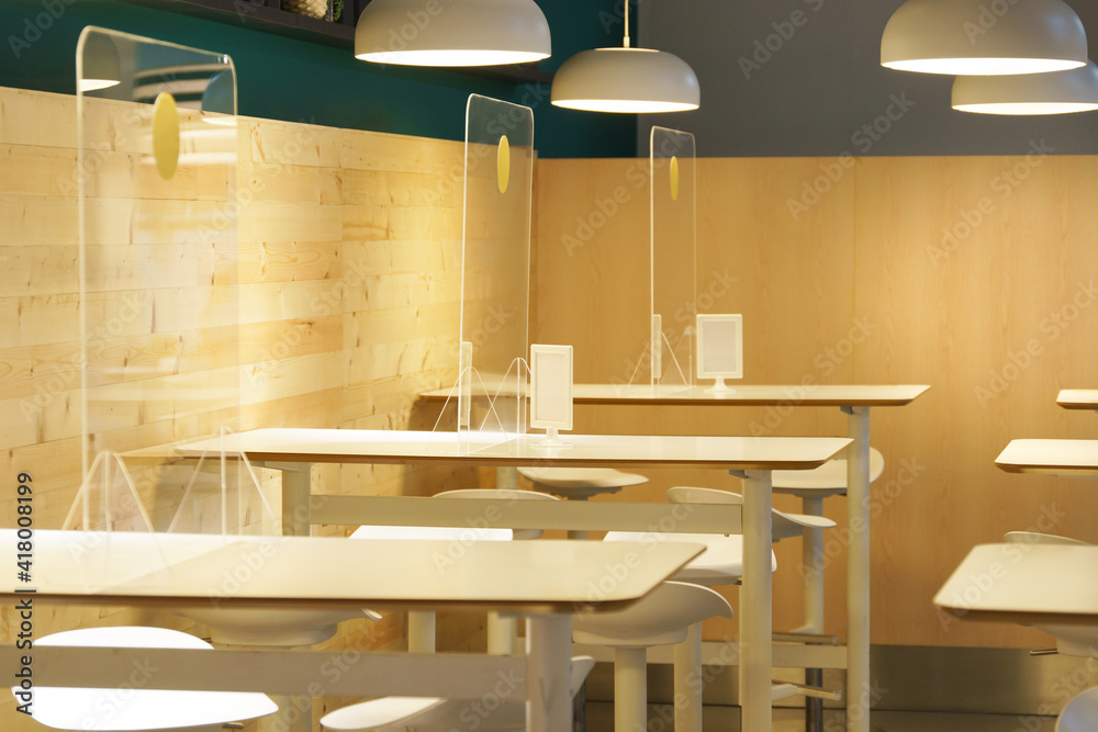 Clear acrylic or plastic divider, barrier or partition on empty table