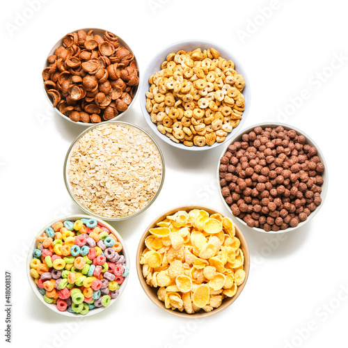 Bowls with different cereals on white background
