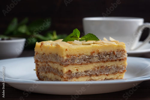 Banana sponge cake with nuts and mint. Delicious sweet dessert for tea  Dark wooden background.