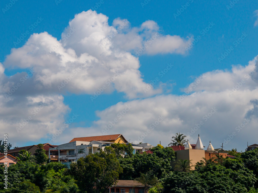 Clouds Gathering Above Residential Properties with Vegetation