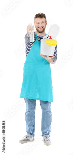 Young man with cleaning supplies on white background