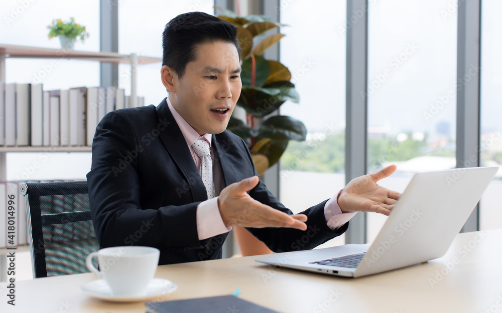 Ethnic businessman sitting and working in office. Ethnic businessman sitting and working in office.
