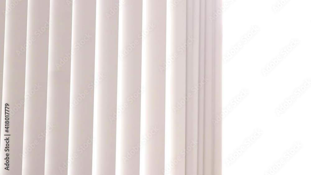 pulling vertical blinds curtain back revealing bright sunlight - medium pulling vertical blinds curtain back revealing bright sunlight - medium