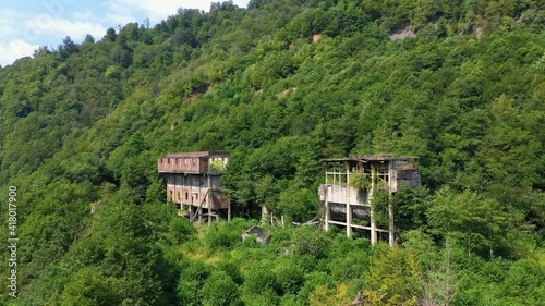 Ruined lost overgrown mining ghost town Akarmara, consequences of war in Abkhazia, aerial view from drone photo