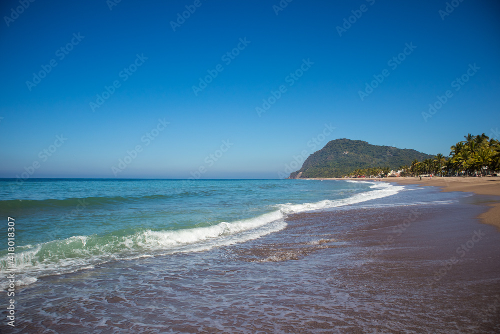 Waves breaking on the beach of the Pacific Ocean in Lo de Marcos, Riviera Nayarit, Mexico.