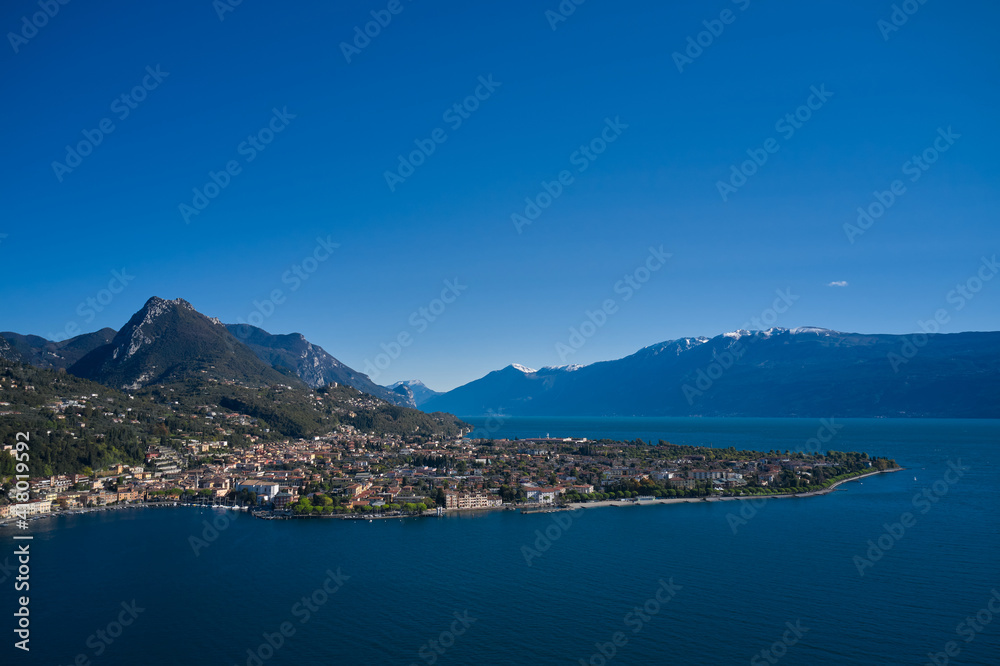 Panoramic view of the historic city of Toscolano Maderno on Lake Garda Italy. Aerial view of the town on Lake Garda. Tourist place on Lake Garda in the background Alps and blue sky.