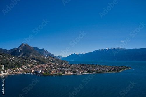 Panoramic view of the historic city of Toscolano Maderno on Lake Garda Italy. Aerial view of the town on Lake Garda. Tourist place on Lake Garda in the background Alps and blue sky.