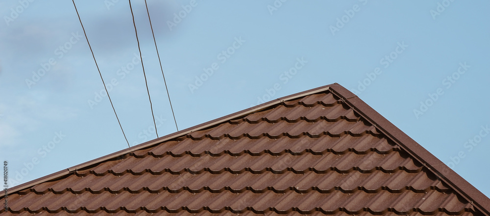 brown tiled roof and wires above it on a sunny day brown tiled roof and wires above it on a sunny day