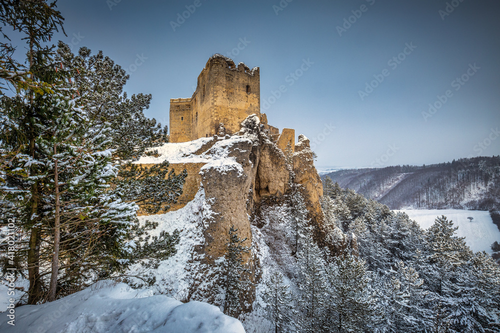 The medieval castle Lietava on a rocky reef with view of the surrounding landscape in winter, Slovakia, Europe.