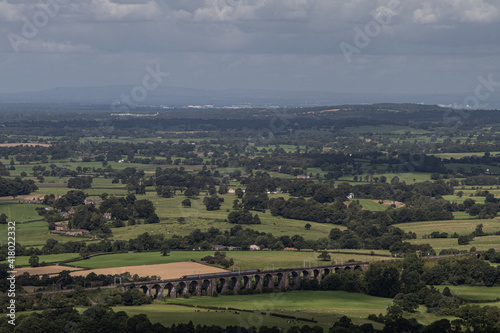 A panoramic British view with a train track viaduct visible in the distance
