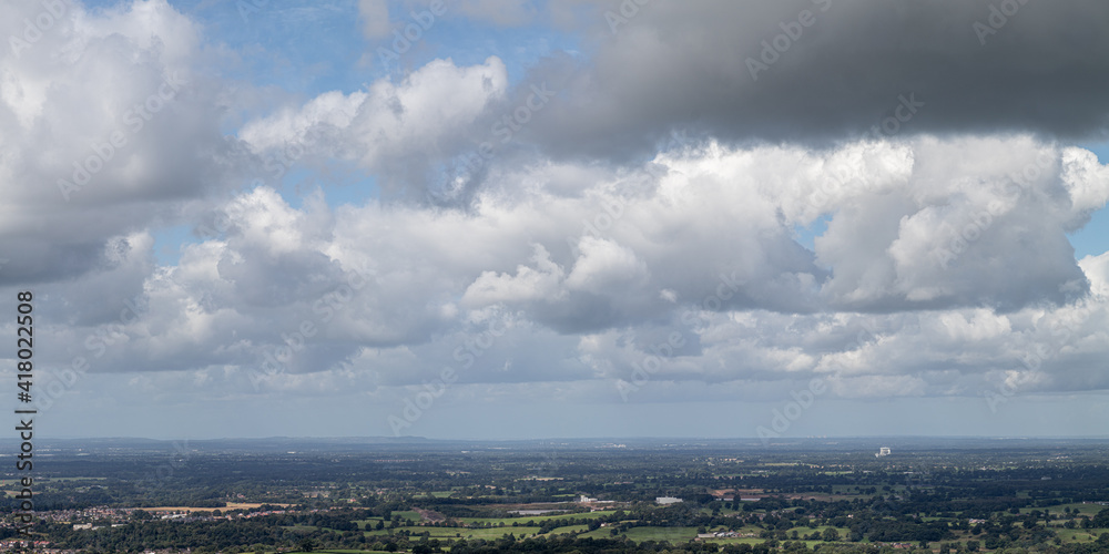 Panoramic views of the British countryside, with a lot of white fluffy clouds 