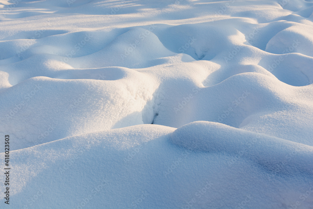 Snowy wavy texture with harsh blue shadows. Sunset Snowy wavy texture with harsh blue shadows. Sunset