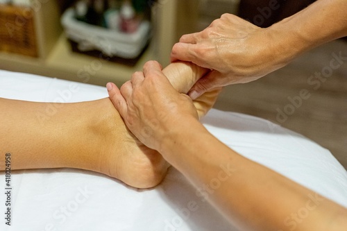 Masseuse giving a foot massage to a client