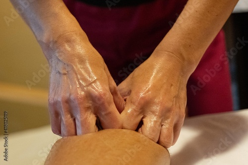 Masseuse giving a leg massage to a client