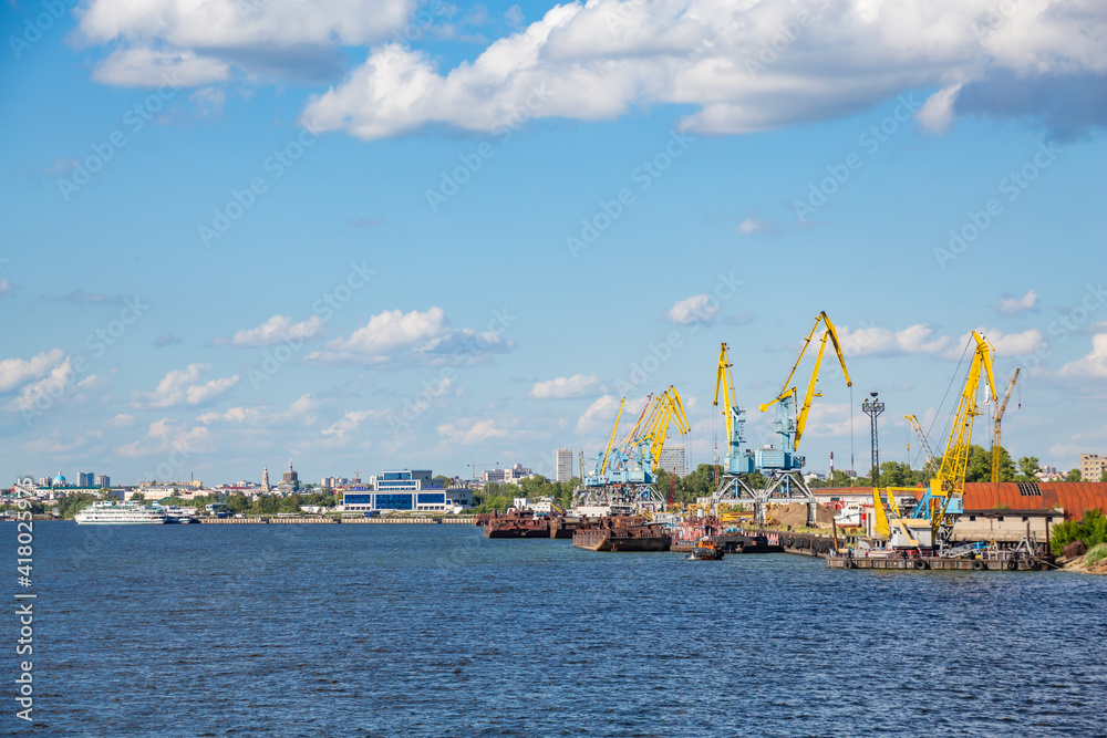 Cargo river port on the Volga River in the city of Kazan. Republic of Tatarstan, Russia. Ships at the docks. A sunny summer day.