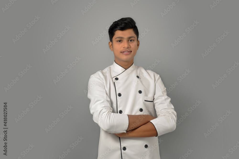 Happy male Indian chef Standing over grey background profession and people concept Happy male Indian chef Standing over grey background profession and people concept
