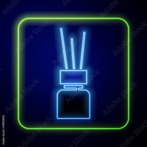 Glowing neon Aroma diffuser icon isolated on blue background. Glass jar different with wooden aroma sticks. Vector.