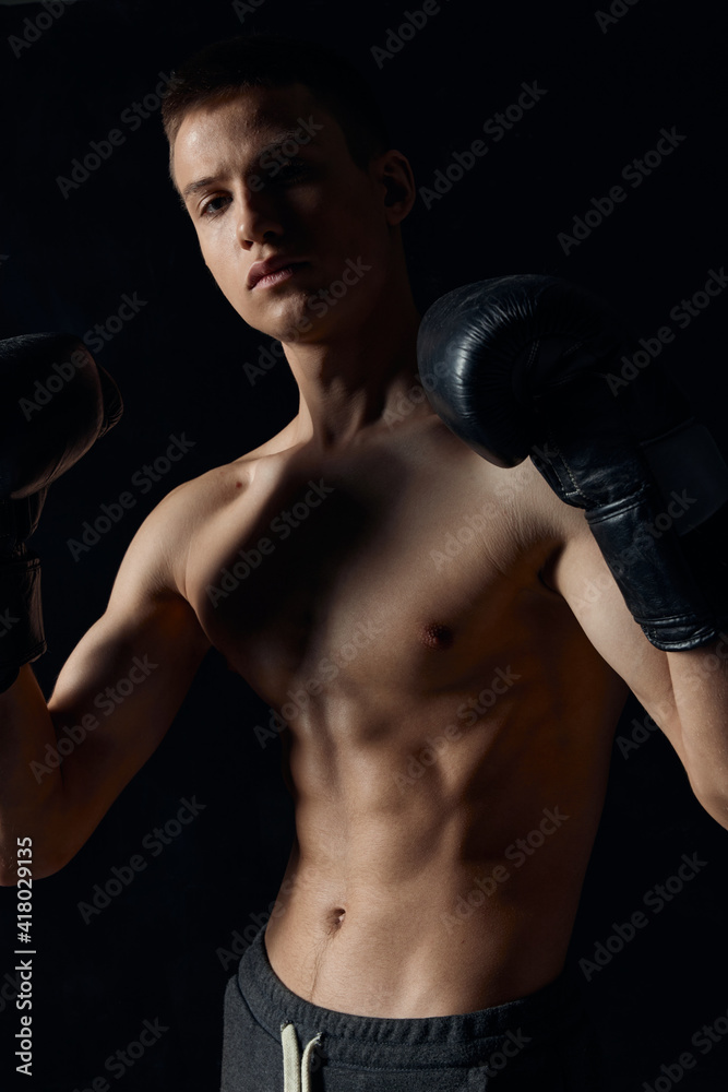 boxer in black gloves on a dark background inflated torso bodybuilder 
