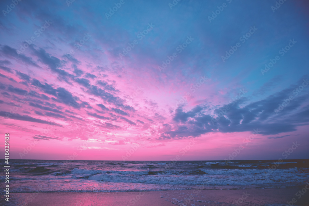 Seascape in the evening. Sunset over the sea with the beautiful cloudy blazing sky