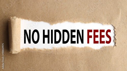 No Hidden Fees . text on white paper over torn paper background.
