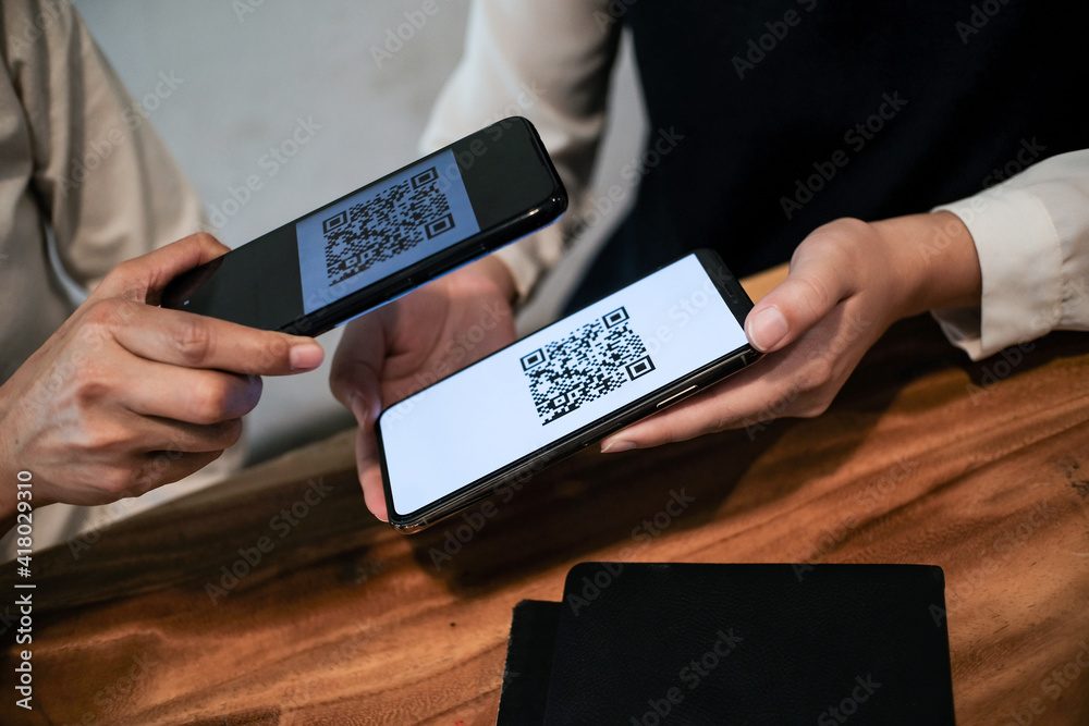 Qr code payment. Woman scanning QR code online shopping cashless ...