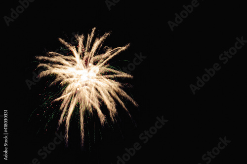 Image with a black background prepared to edit text of a firework  formed by a star with several branches of raw white color accompanied by traces and green dots.- 3