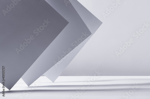 Abstract white grey minimalist background with asymmetric standing sheets with perspective, light and shadow, stripes as border, copy space.