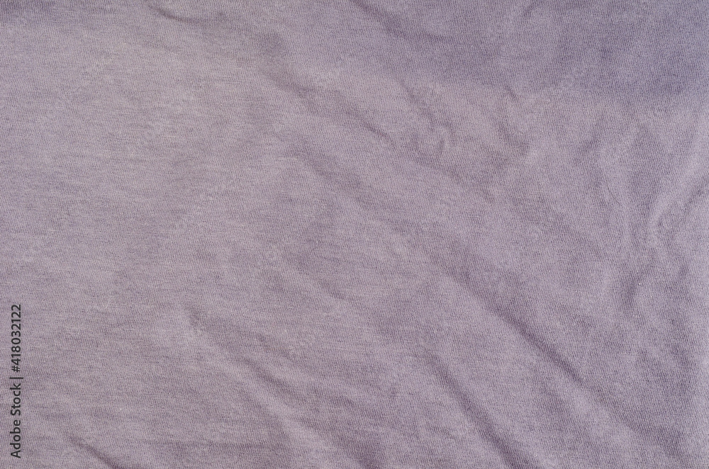 Crumpled light lilac fabric background.