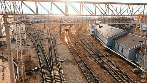 Railway. Industrial landscape. Station. Metal constructions. Perspective view. Vertical Horizontal wallpaper.