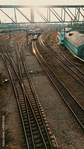 Railway. Industrial landscape. Station. Metal constructions. Perspective view. Vertical Horizontal wallpaper.