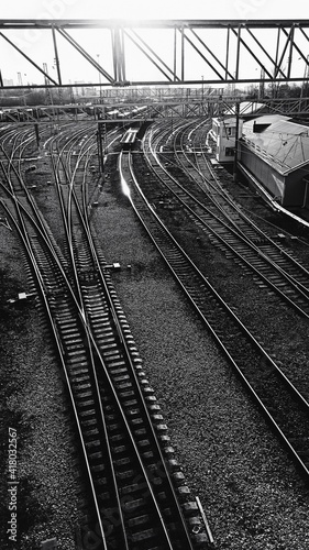 Railway. Industrial landscape. Station. Metal constructions. Perspective view. Vertical wallpaper.