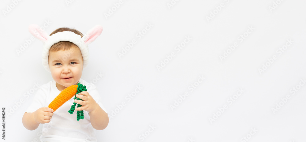 baby boy on a white background with rabbits ears A small boy with Bunny ears and a carrot. On white background with copy space baby boy on a white background with rabbits ears A small boy with Bunny ears and a carrot. On white background with copy space