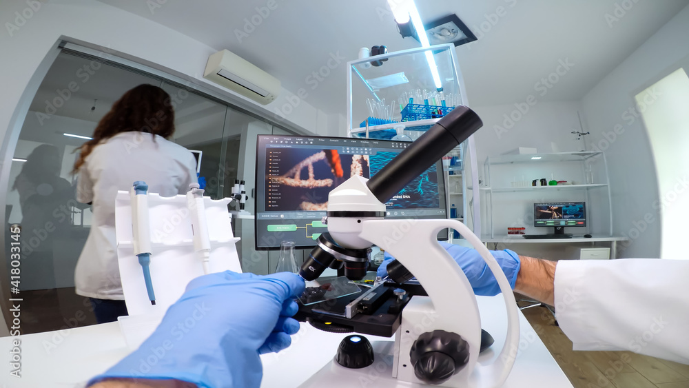 FPV of medical scientist looking under microscope, analyzes petri dish ...