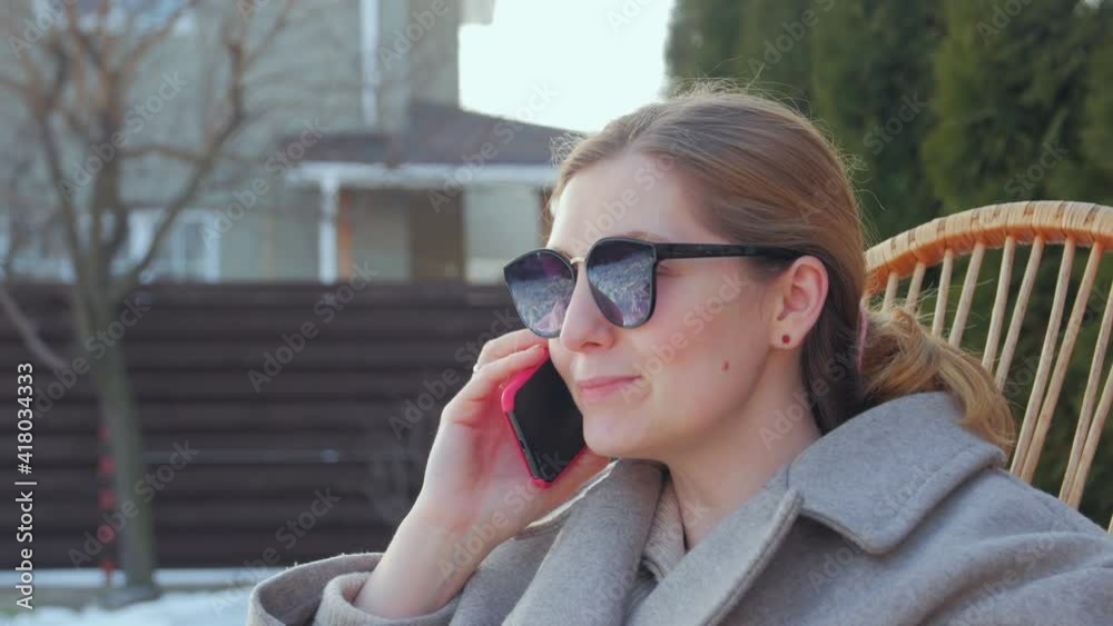 Woman in sunglasses talking on phone closeup camera movement Woman in sunglasses talking on phone closeup camera movement