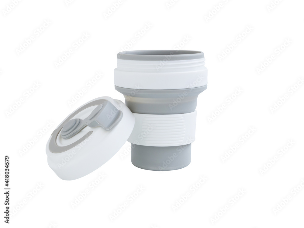 Empty Gray-white foldable silicone mug with lid for hot and cold drinks, portable, eco-friendly, reusable, Zero waste concept. Empty Gray-white foldable silicone mug with lid for hot and cold drinks, portable, eco-friendly, reusable, Zero waste concept.