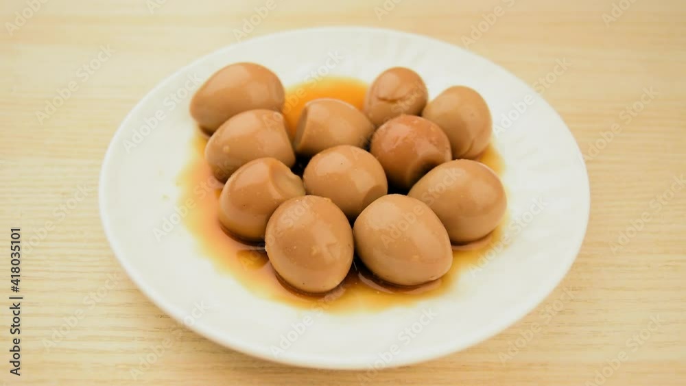 A dish of quail eggs seasoned with soy sauce A dish of quail eggs seasoned with soy sauce
