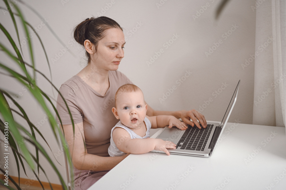 Young mother work studying from home with laptop computer during quarantine, little cute toddler baby on lap. Home office, parenthood. Remote work, distance education. Video conference virtual event. Young mother work studying from home with laptop computer during quarantine, little cute toddler baby on lap. Home office, parenthood. Remote work, distance education. Video conference virtual event.