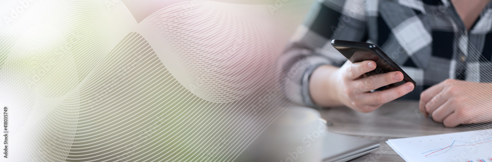 Fototapeta premium Female hands using a smartphone; panoramic banner