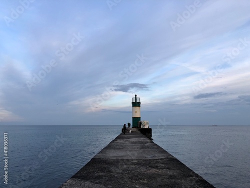 calm sea with beautiful sunset sky and lighthouse