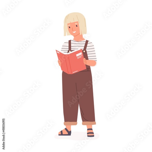 Happy smart girl standing and reading book. Smiling kid holding textbook and ...