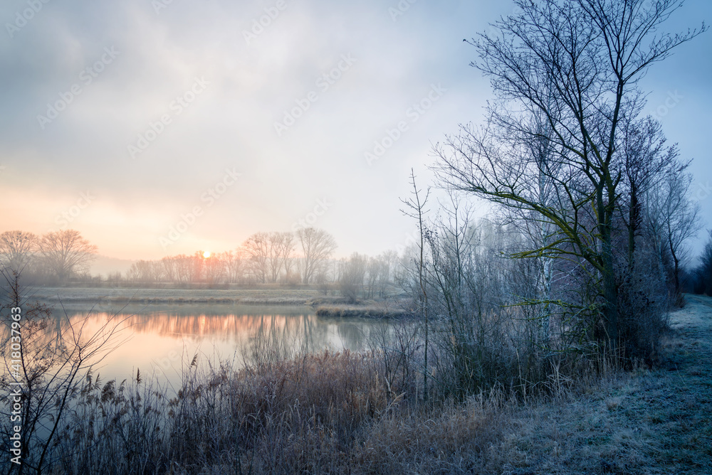 Hoarfrost and mist on the lake in the morning