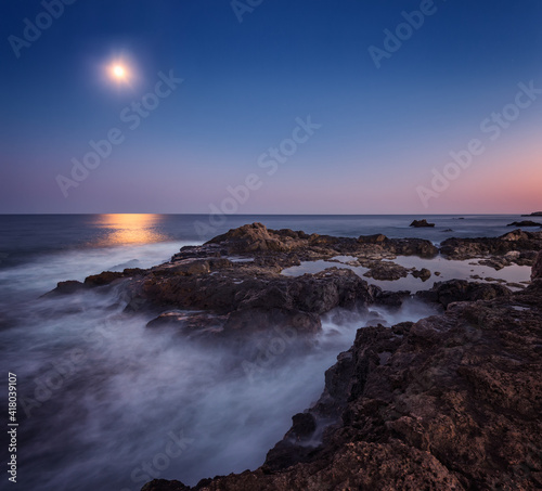 On the moonlight.Long time exposure night landscape with full moon above the rocky Black sea coast