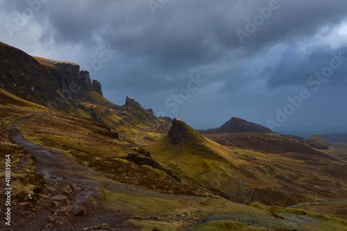 hills, peaks and rocks in scenery of The Quiraing on the Isle of Skye with a sheep in a cloudy day , Scotland