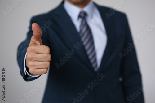 Male hand showing OK or confirm sign with thumb up during conference closeup. High level and quality product, serious offer, mediation solution, happy client, creative adviser participation concept