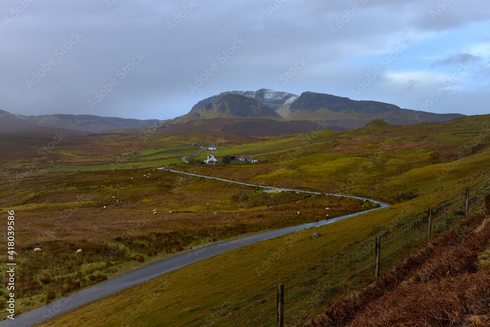 Scenic view of road and farm close the Quiraing mountains in Isle of Skye, Scottish high