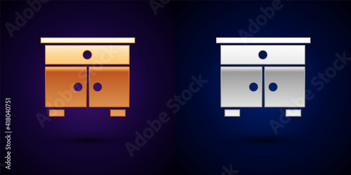 Gold and silver Furniture nightstand icon isolated on black background. Vector.